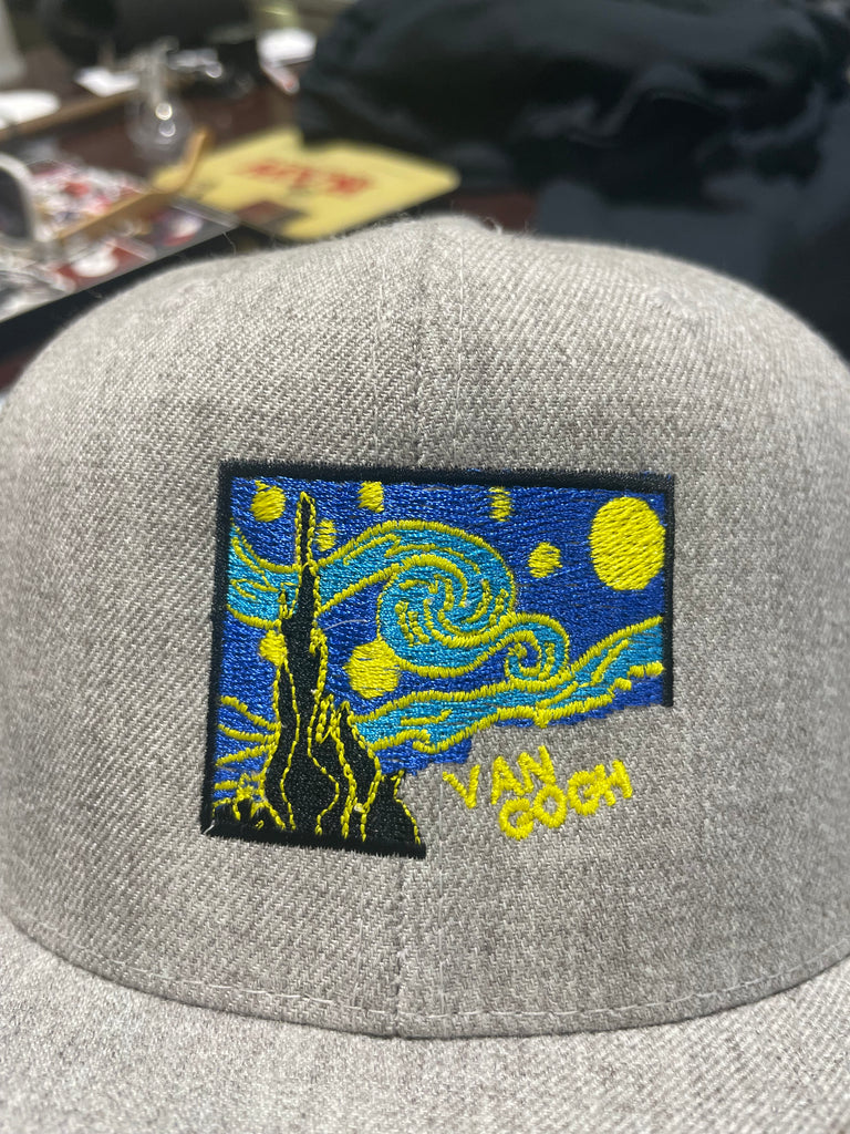 Van Gogh's Stary Night sewn together using modern embroidery techniques on a heather grey cap