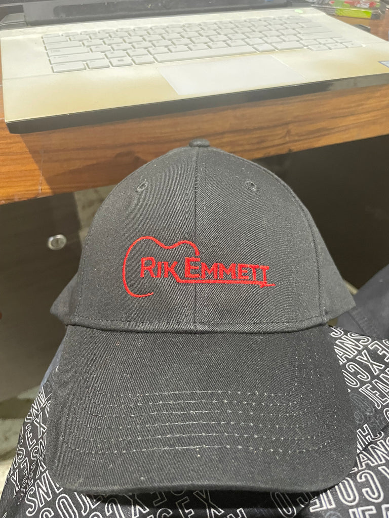RiK Emmett embroidered in red on a hat with a guitar motif