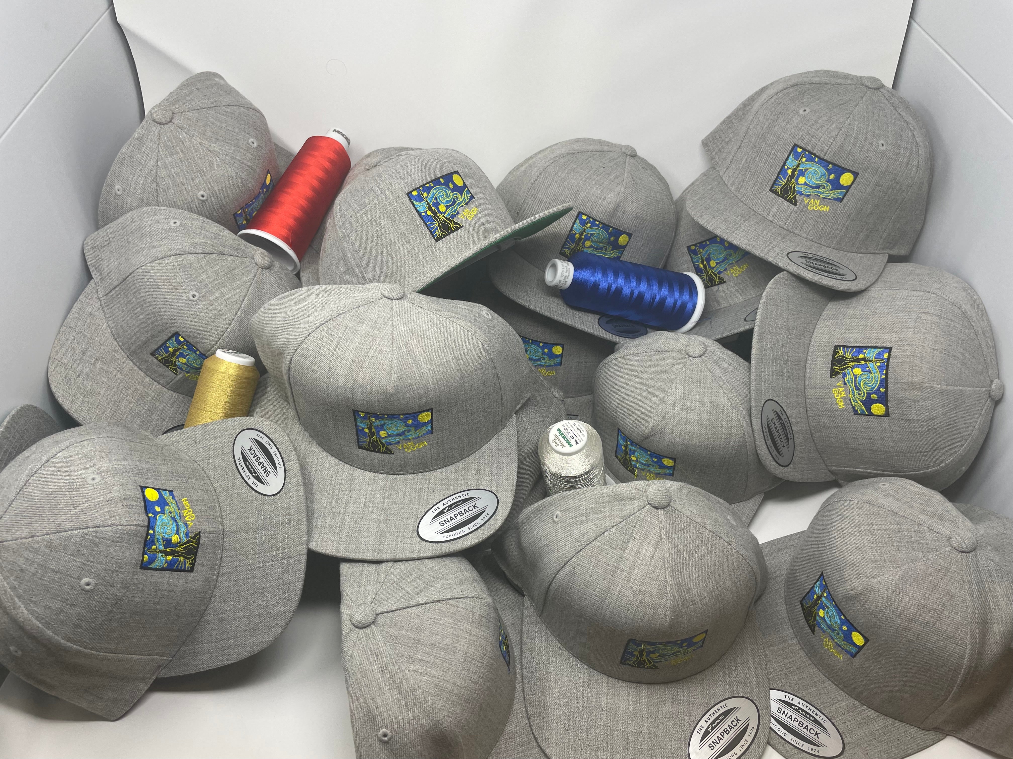 Tubular embroidery on multiple yupong heather hats of Van Gogh's Stary Night in a studio adorned with madeira thread in colours red gold and blue