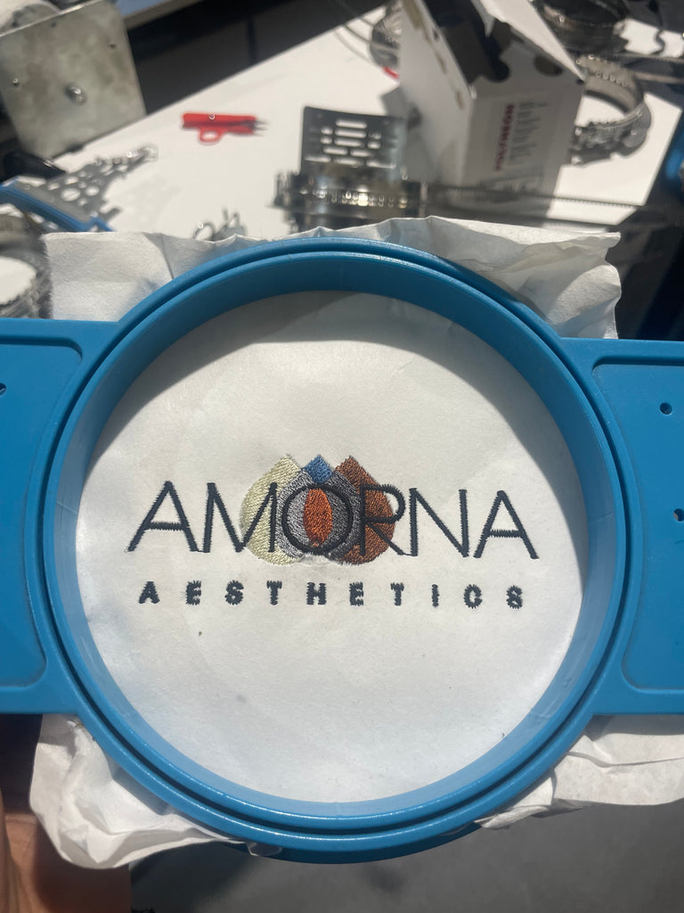 AMORNA Aesthetics embroidered on pelon with grey, brown and cream droplets in the background