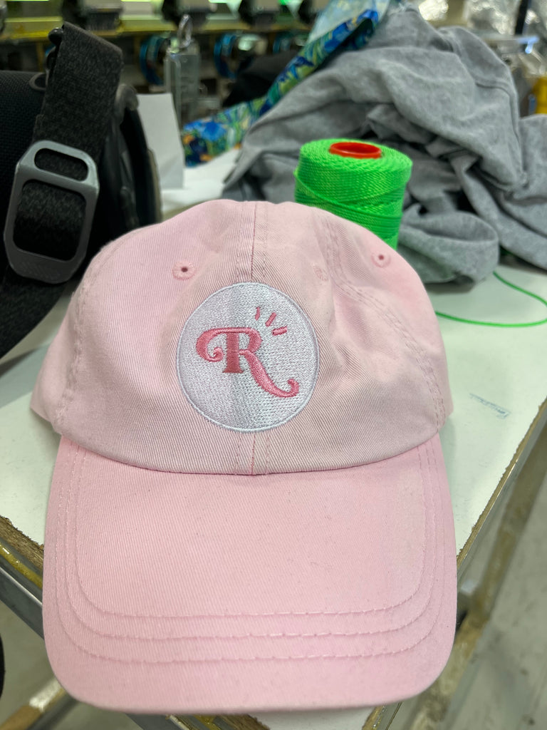 Script Font R satin stitch embroidery on a pink hat for rose picnic