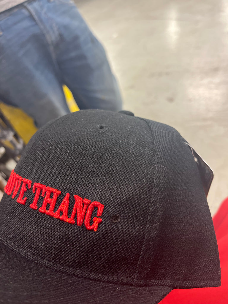 Love Thang puff embroidery in red on a black baseball cap